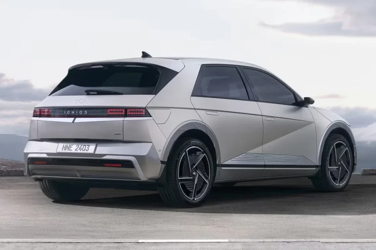 Hyundai IONIQ 5 lease - schuin achteraanzicht met pixel-vormige achterlichten aan de kust