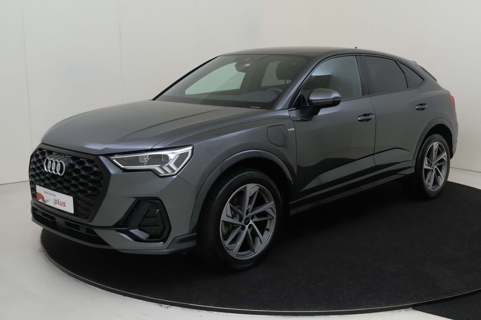 Audi Q3 Sportback occasion lease - schuin vooraanzicht van de grijze SUV op een draaiplateau