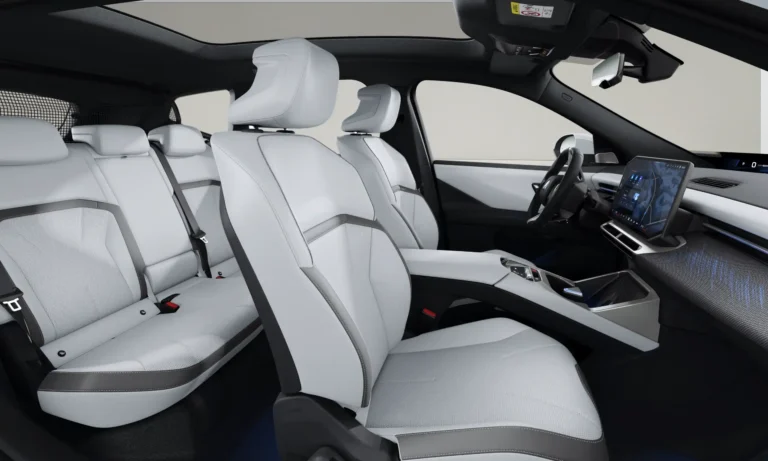 BMW iX3 zakelijk leasen - interieur met dashboard en stuurwiel gezien vanaf de achterbank